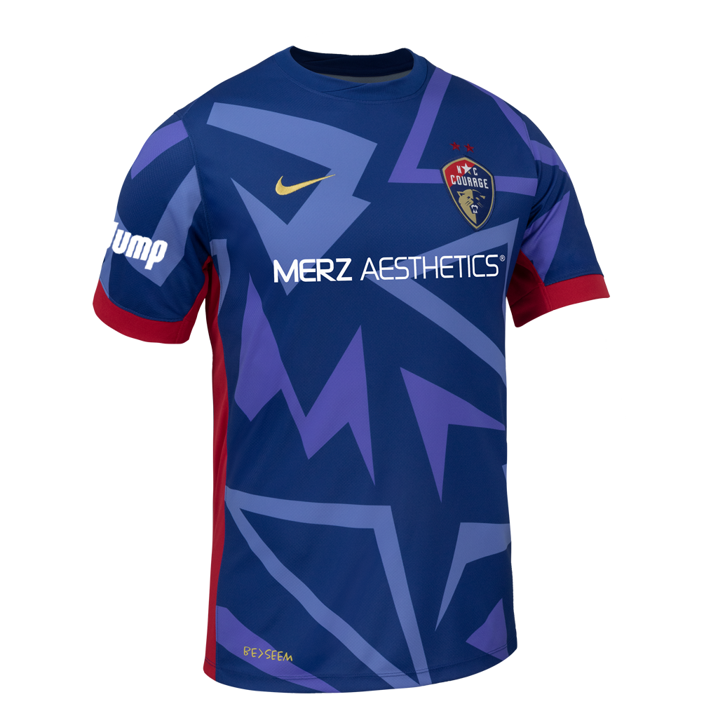 2025 Blue "The Belong" regular fit Kit with blue triangle designs, red rims on sleeve, NC Courage Logo and gold Nike logo, and Merz logo.