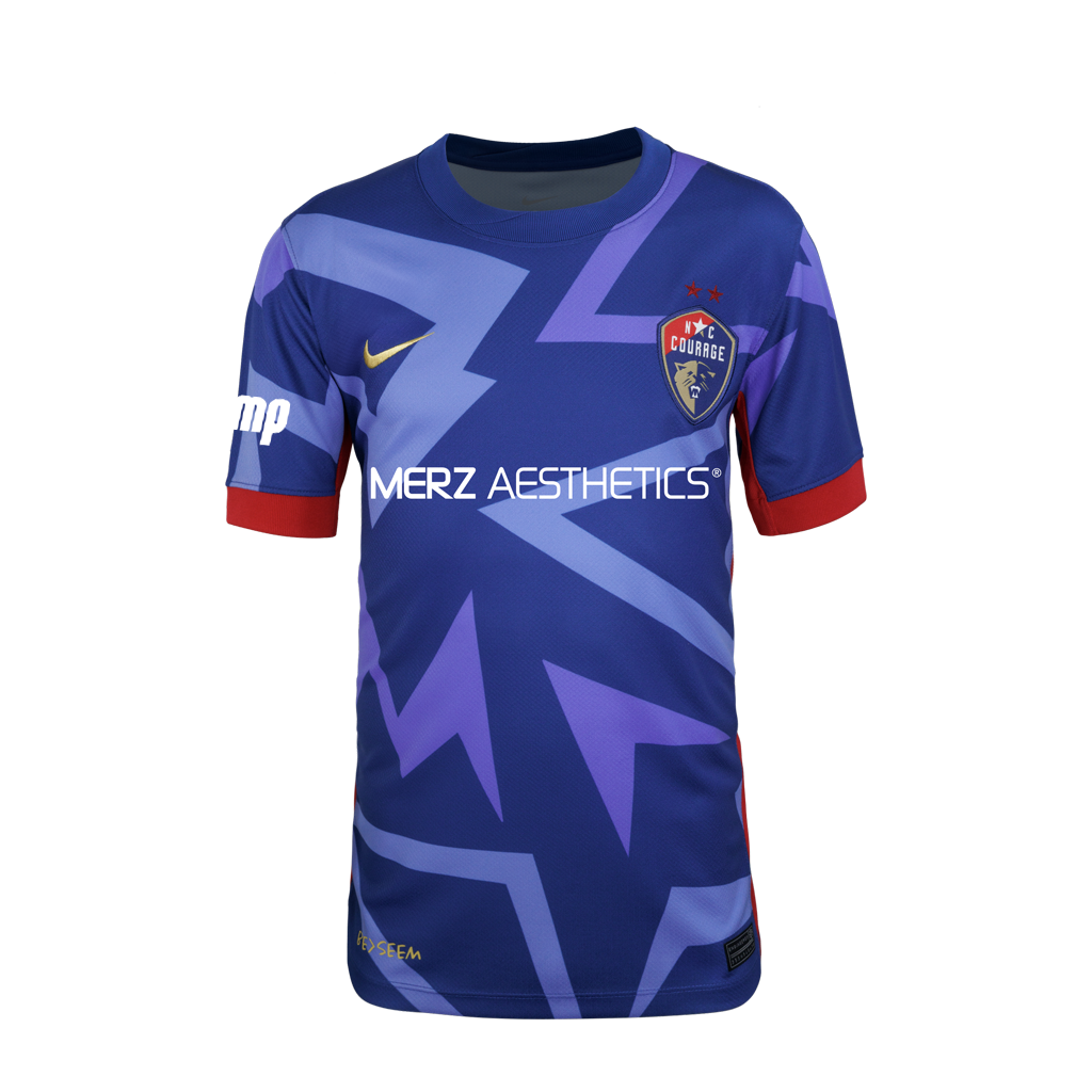 2025 Blue "The Belong" Youth fit Kit with blue triangle designs, red rims on sleeve, NC Courage Logo and gold Nike logo, and Merz logo.