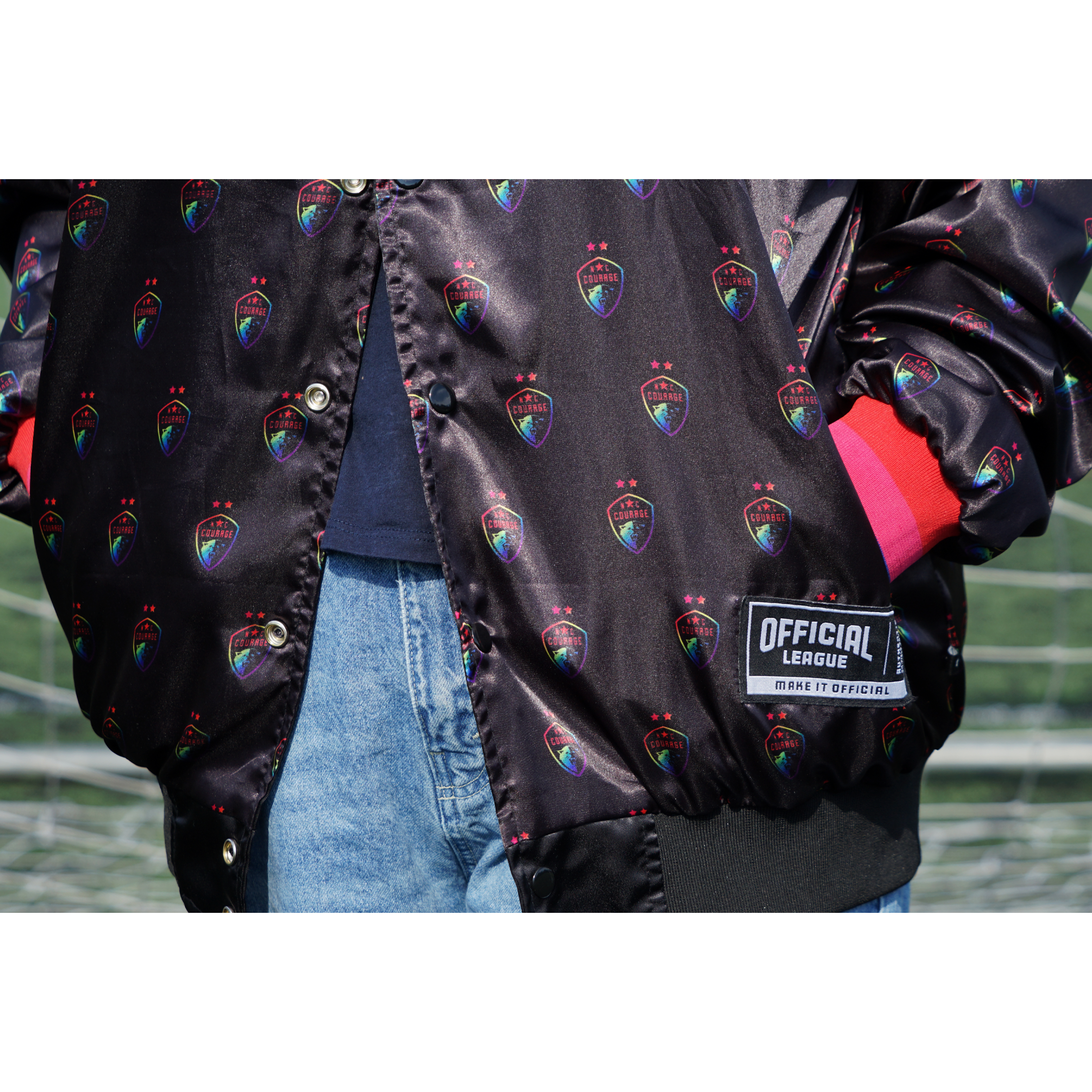 A closeup of the pride logo on the black satin jacket.