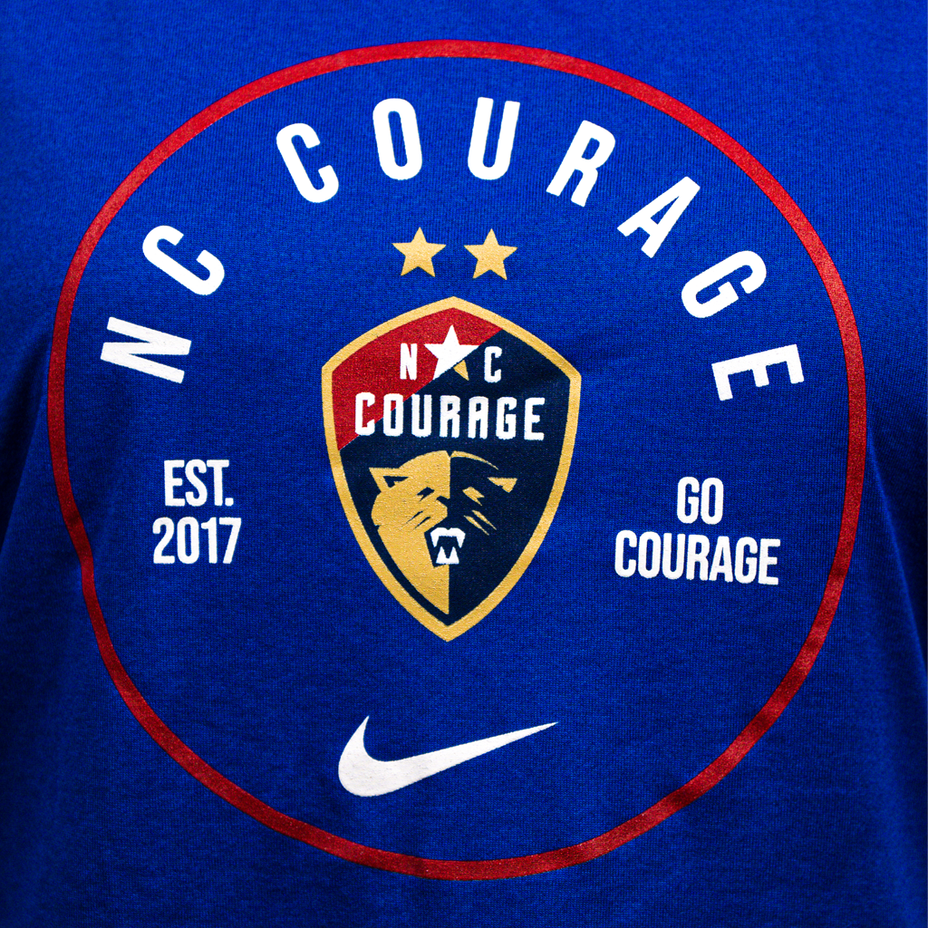 A zoom in of a royal blue tank top with the NC Courage logo in a circle design on the front.