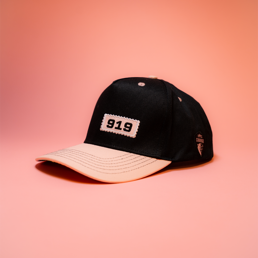 Black and pink cap with '919' logo on a pink background