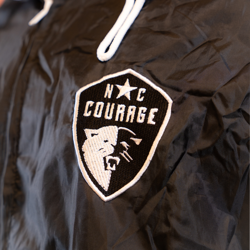 Black jacket with 'NC Courage' logo