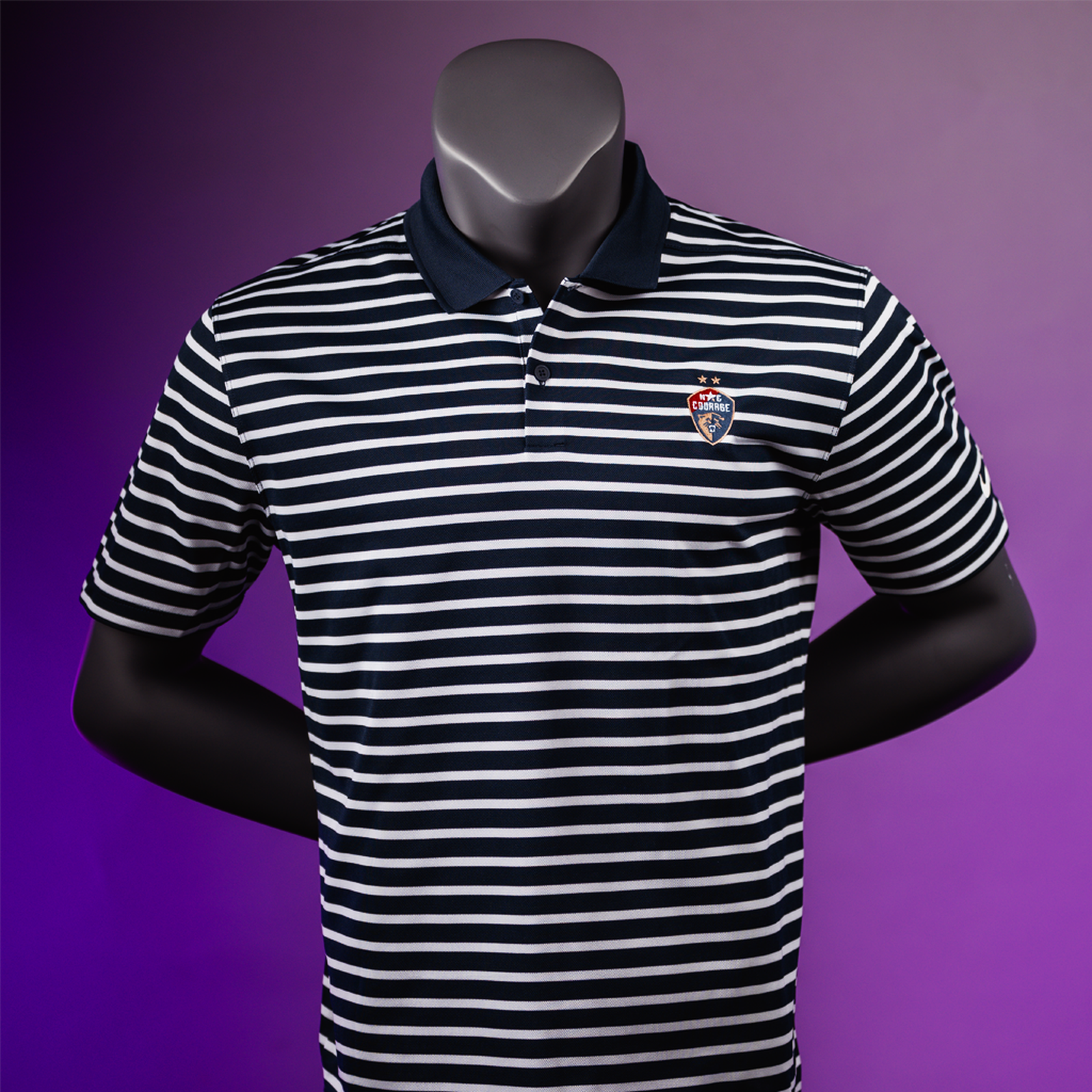 A striped polo shirt displayed on a mannequin, featuring a combination of black and white stripes with a small logo on the chest.
