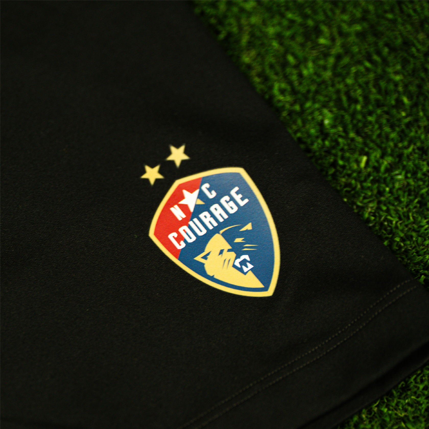 A close up of the a pair of black Nike One 7" biker shorts with the NC Courage logo on the left leg.