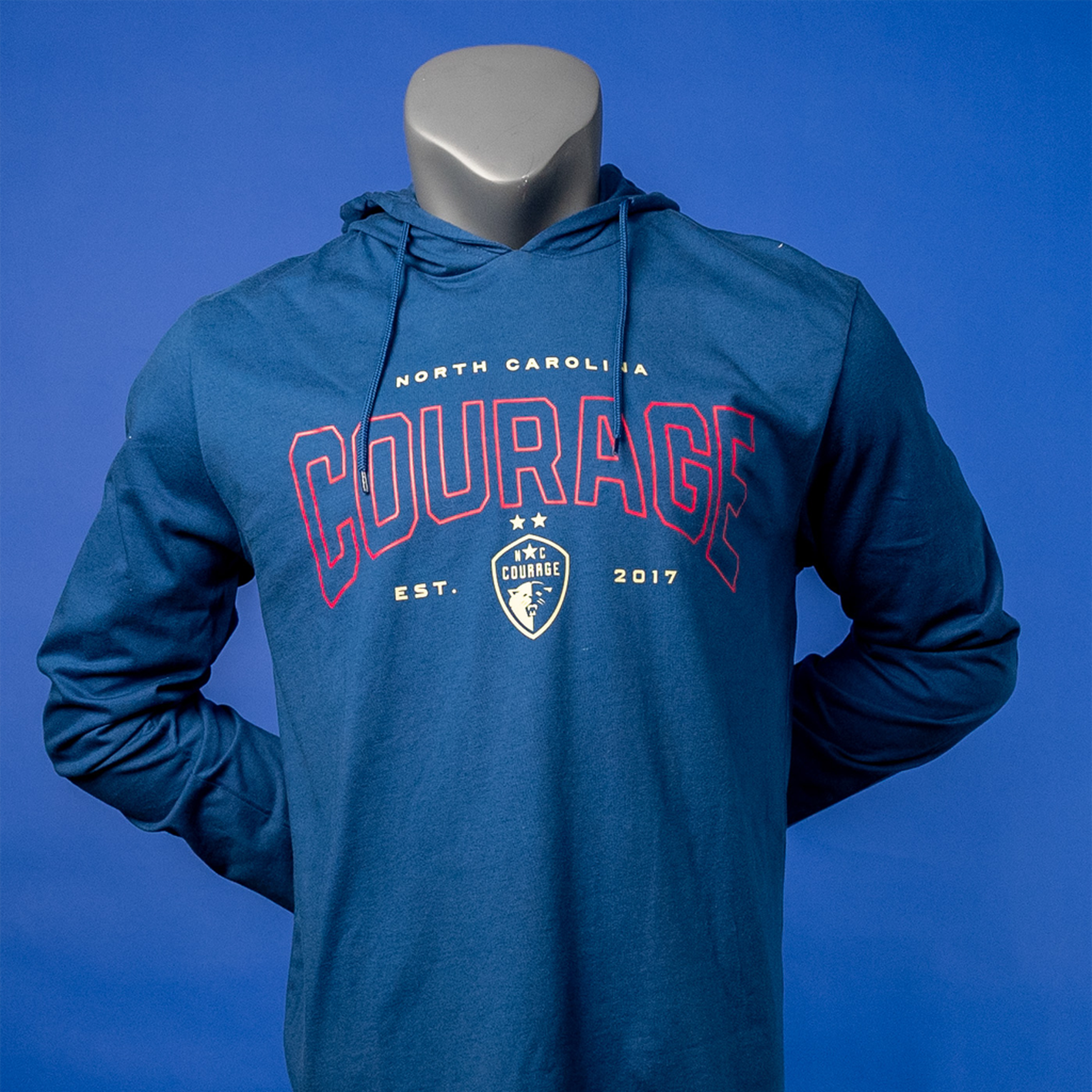 A blue hoodie with the 'NC Courage' logo printed in red and white on the front, displayed on a mannequin.