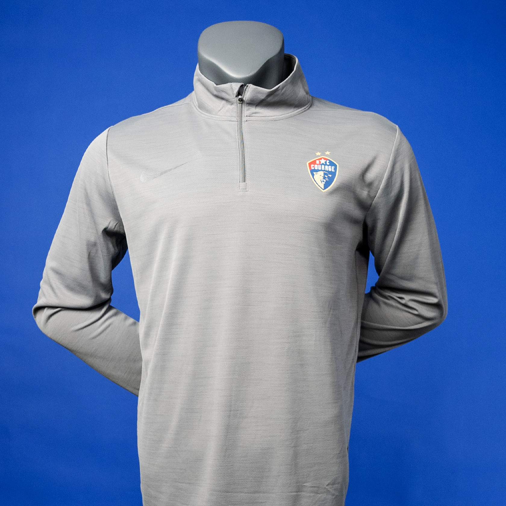 A gunsmoke gray 1/4 zip top with the NC Courage logo displayed on the chest.