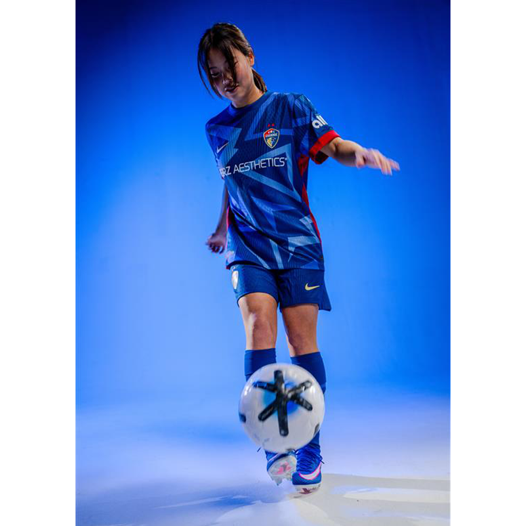 Manaka wearing 2025 Blue "The Belong" juggling soccer ball