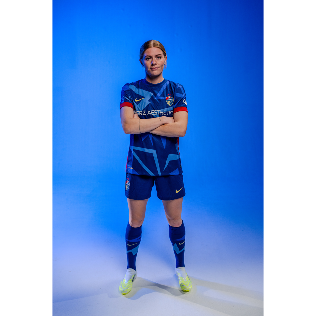 Cortnee Vine posing in the blue kit.