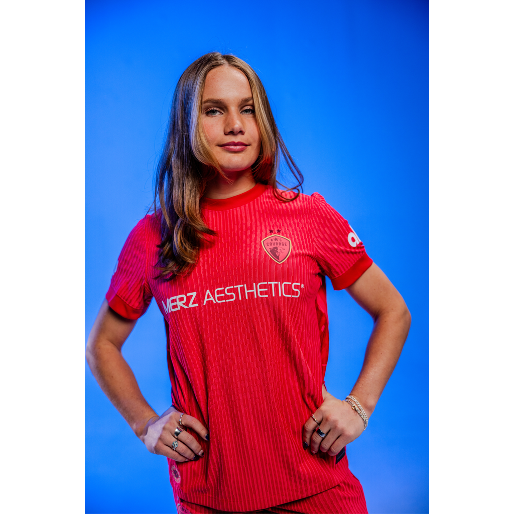 Person wearing a pink athletic outfit with 'Merz Aesthetics' branding on a blue background