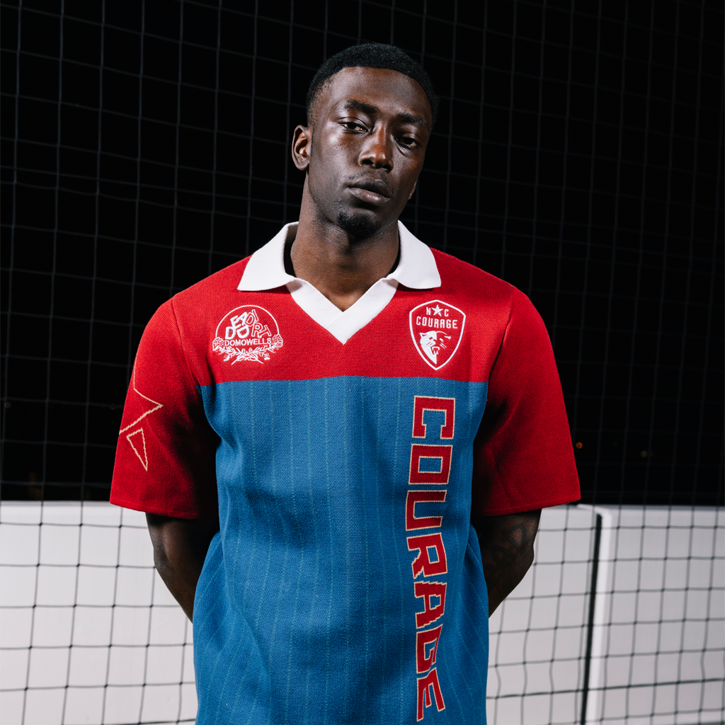 Person wearing a red and blue sports jersey with visible branding and text.