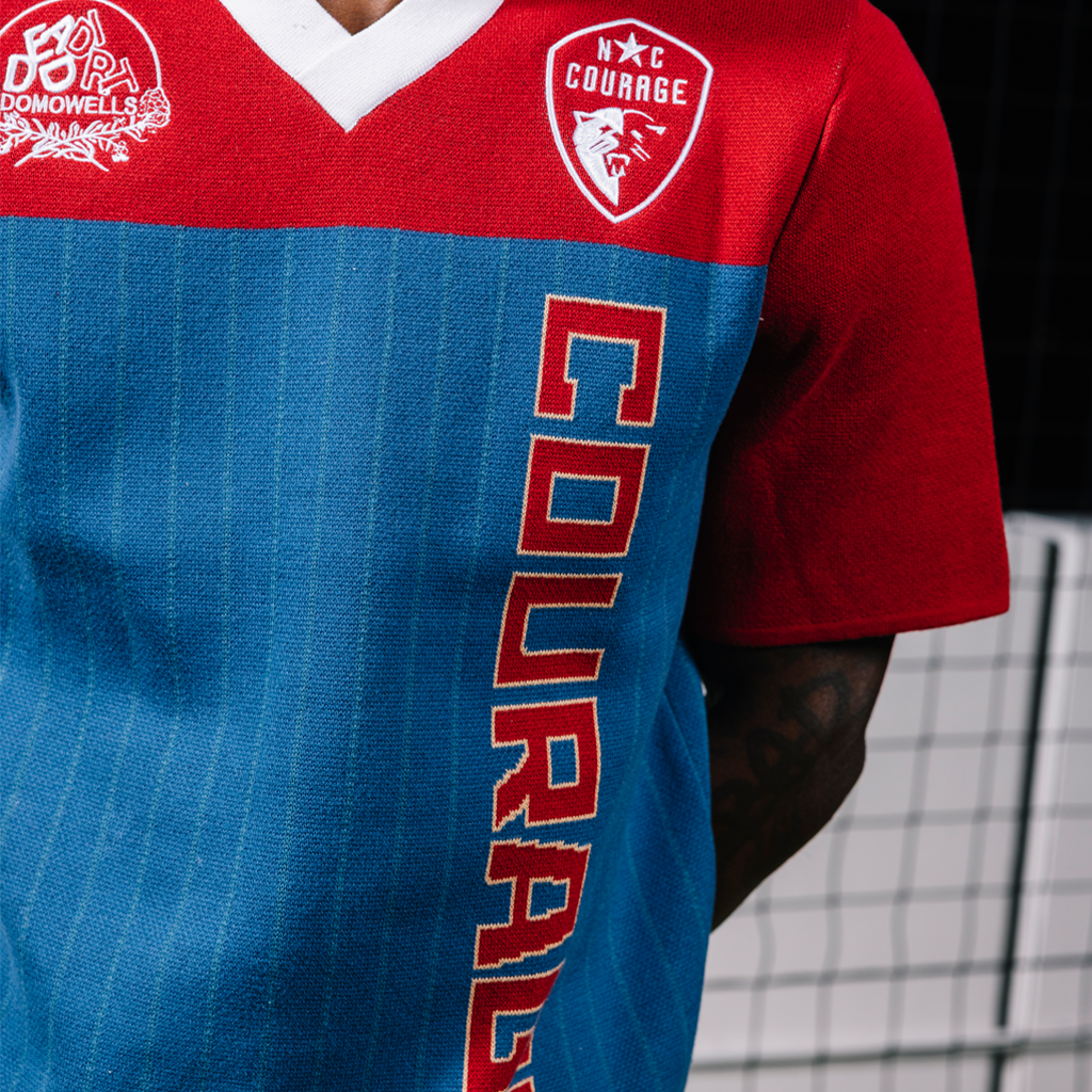 Red and blue sports jersey with visible branding on a dark background