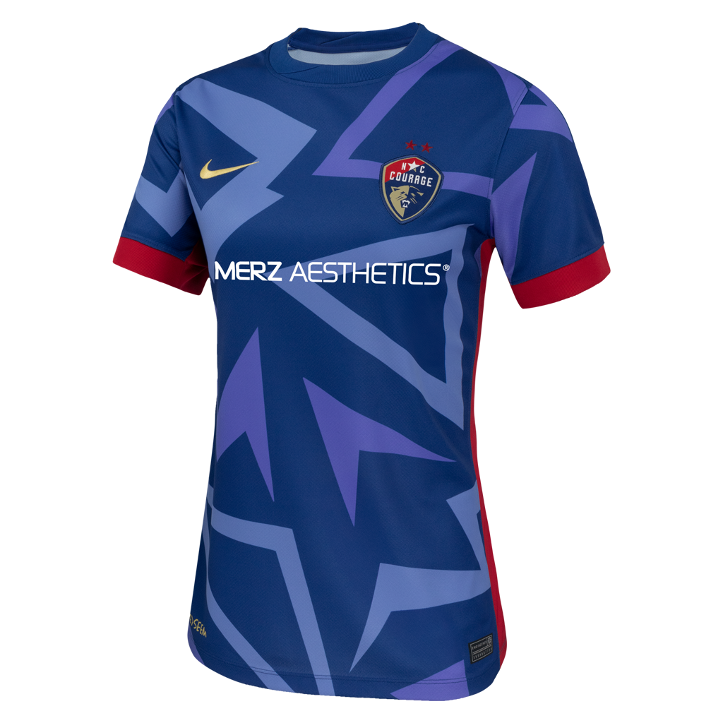 2025 Blue "The Belong" narrow fit Kit with blue triangle designs, red rims on sleeve, NC Courage Logo and gold Nike logo, and Merz logo. 