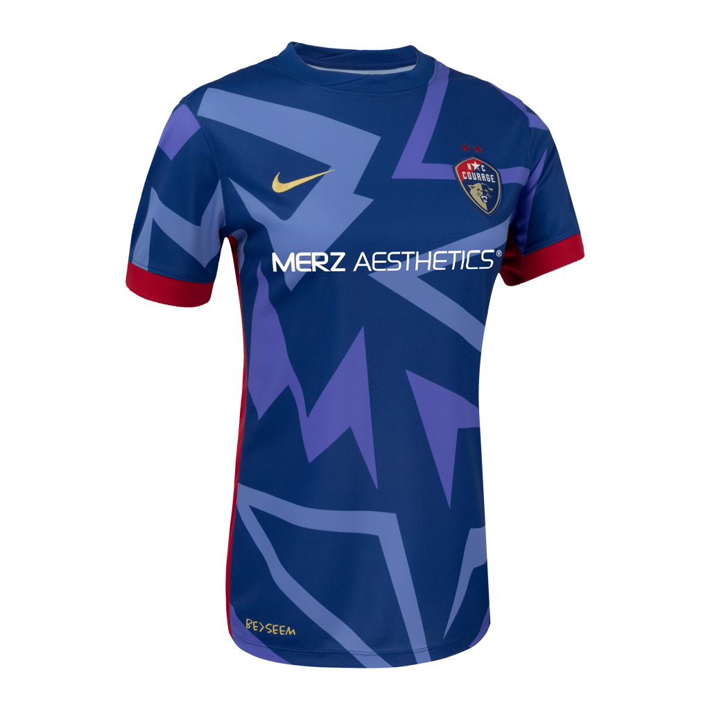 2025 Blue "The Belong" narrow fit Kit with blue triangle designs, red rims on sleeve, NC Courage Logo and gold Nike logo, and Merz logo. 