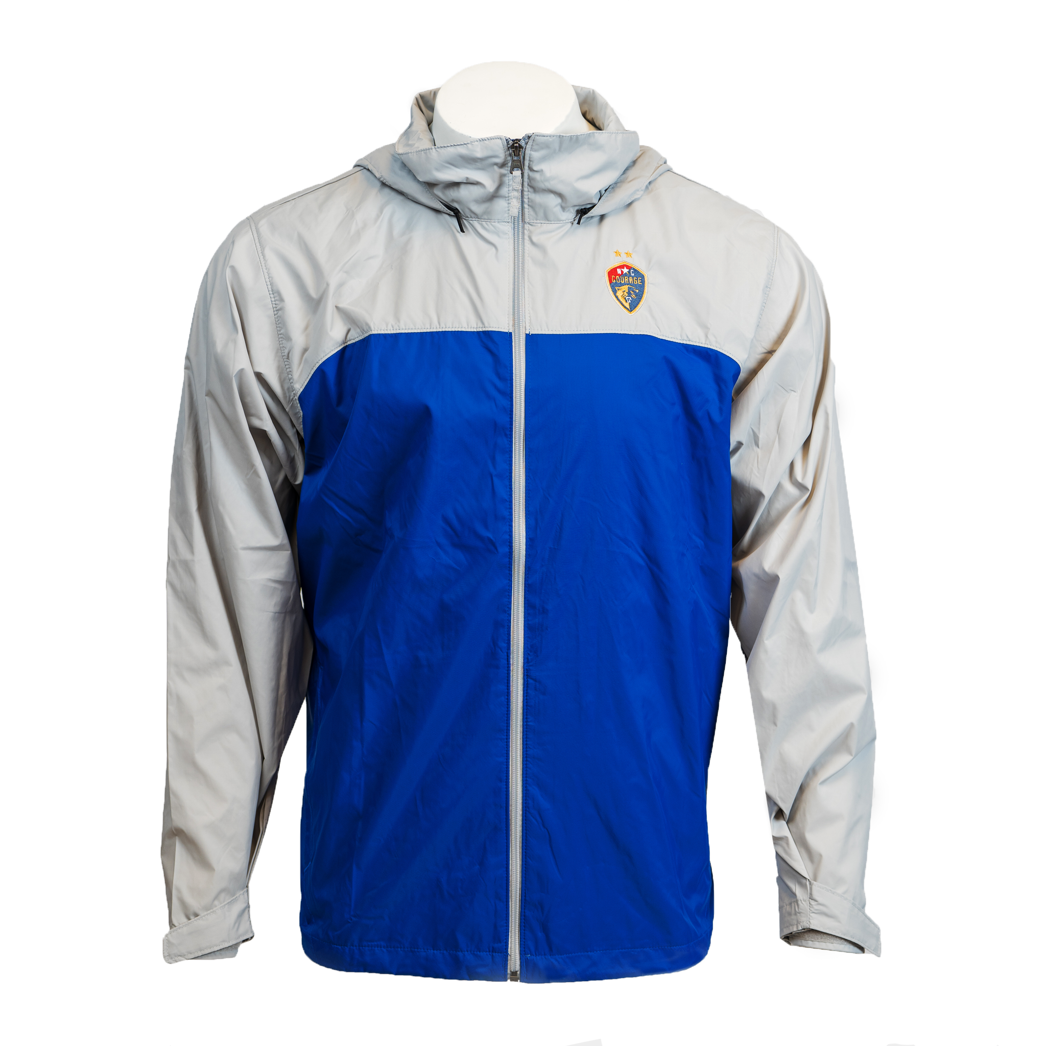A rain jacket with blue and gray colors, featuring a hood and zippered pockets, displaying the NC Courage logo on the chest.