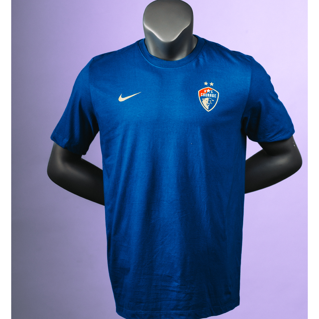 A mannequin wearing a blue Nike jersey tee with the Courage logo on the top right chest.