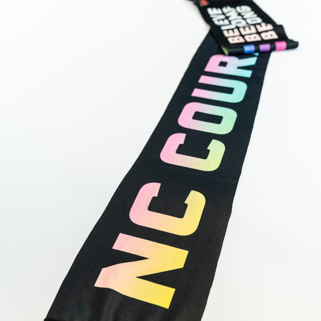 Black scarf with rainbow NC Courage letters