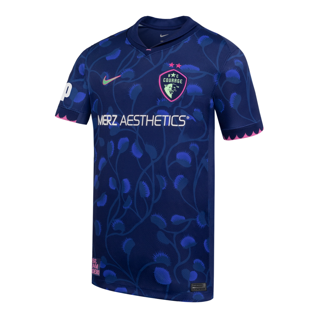 Blue sports jersey with branding and venus flytrap patterns on a white background