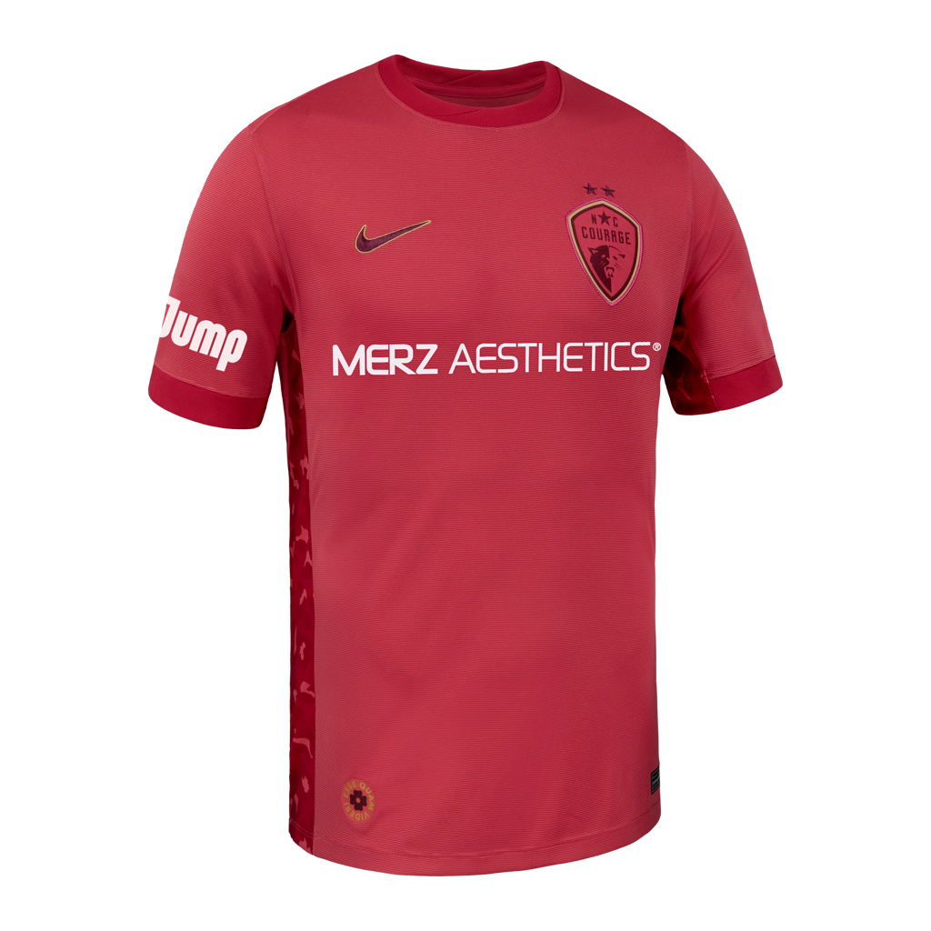 Pink sports jersey with Nike logo and 'Merz Aesthetics' branding on a white background