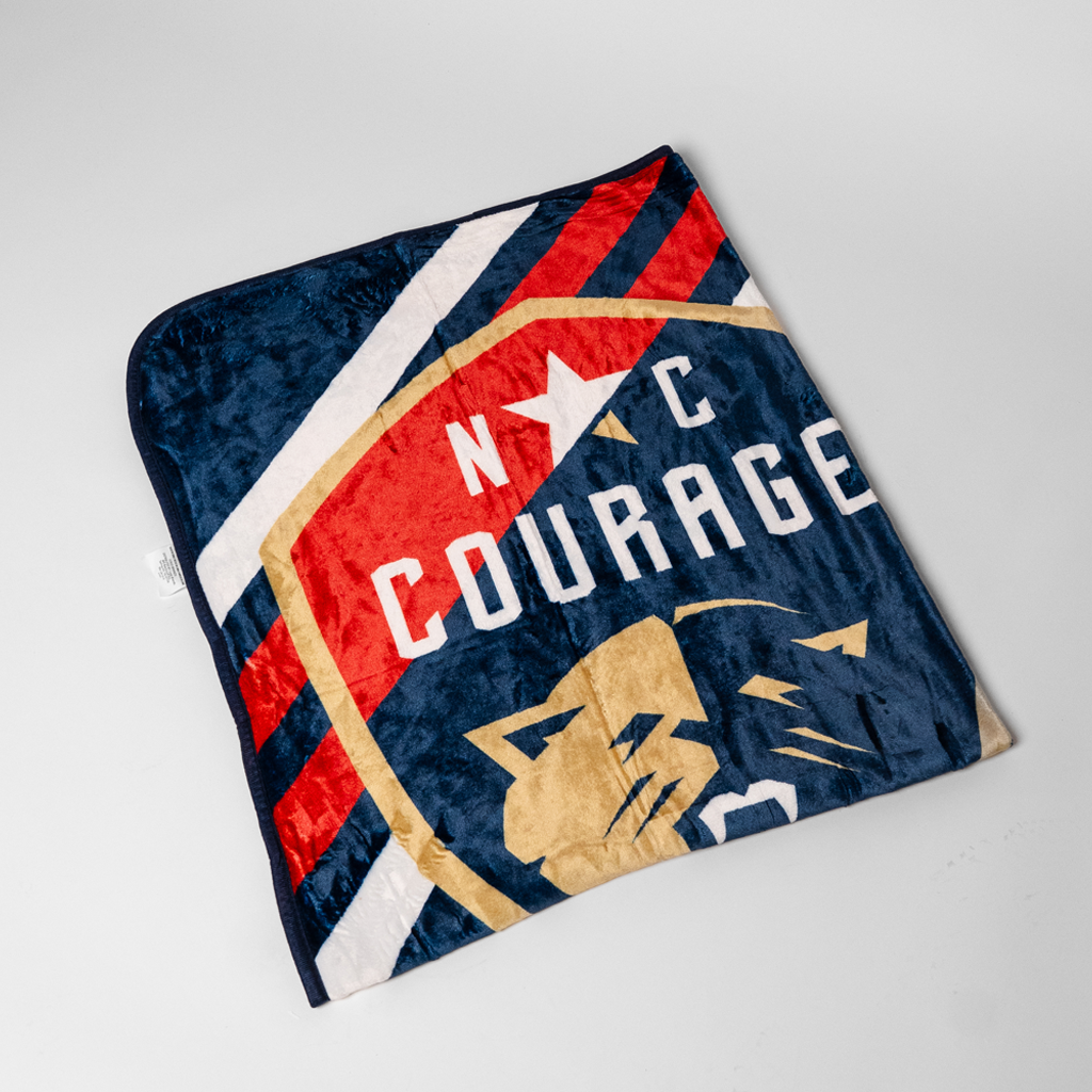 Blanket with 'NC Courage' logo on a white background