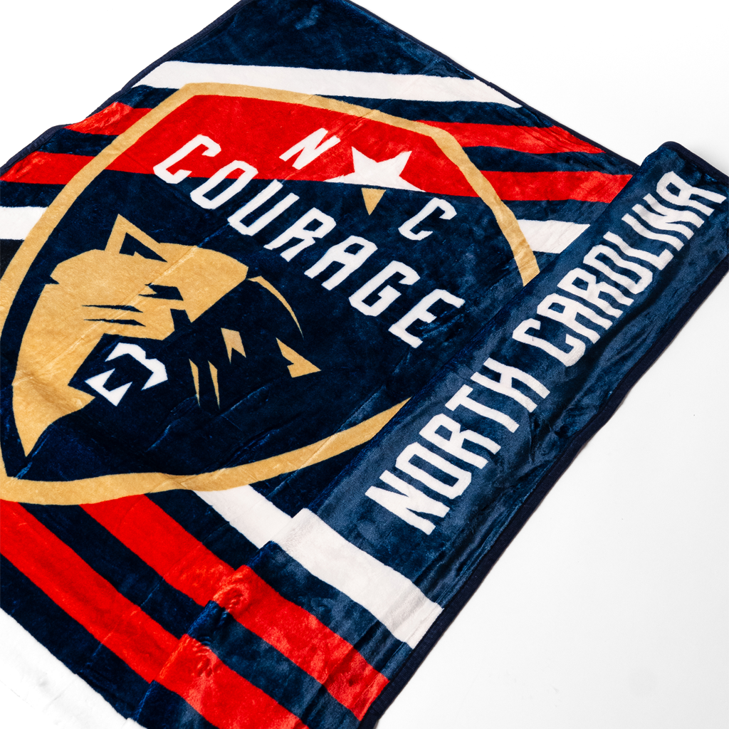 Blanket with 'N C Courage & North Carolina' logo on a white background