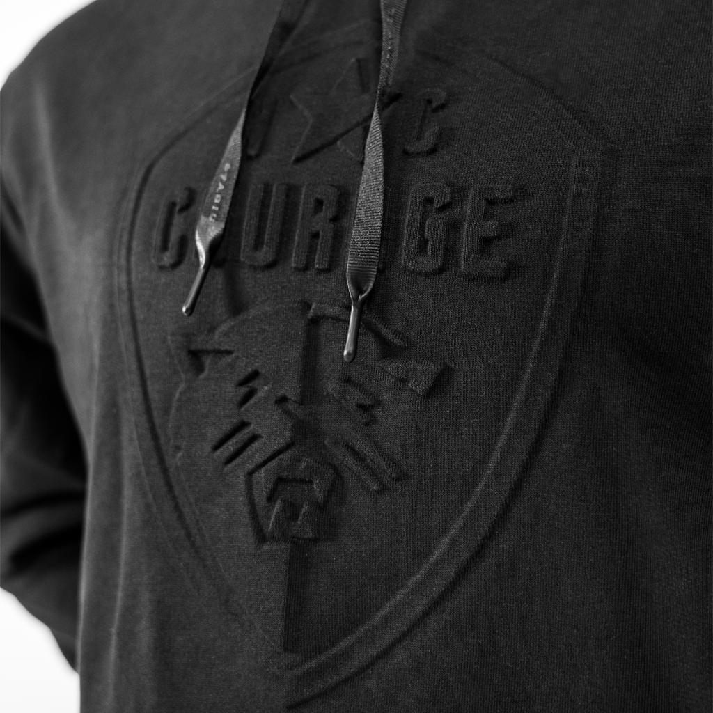 Closeup of NC Courage logo on black hoodie.
