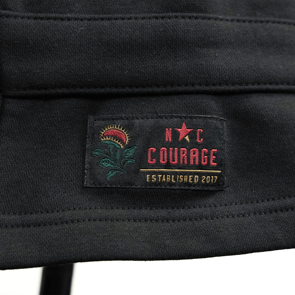 Black jacket with 'N C Courage' logo and text on a dark background