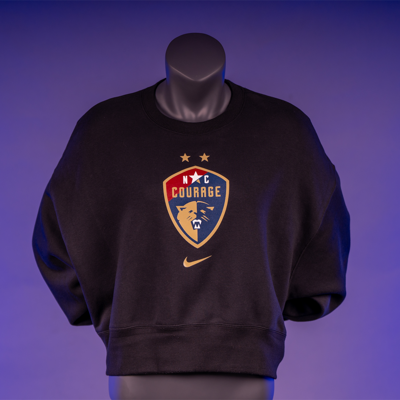 A black cropped oversized crewneck sweatshirt with the NC Courage logo on the front.