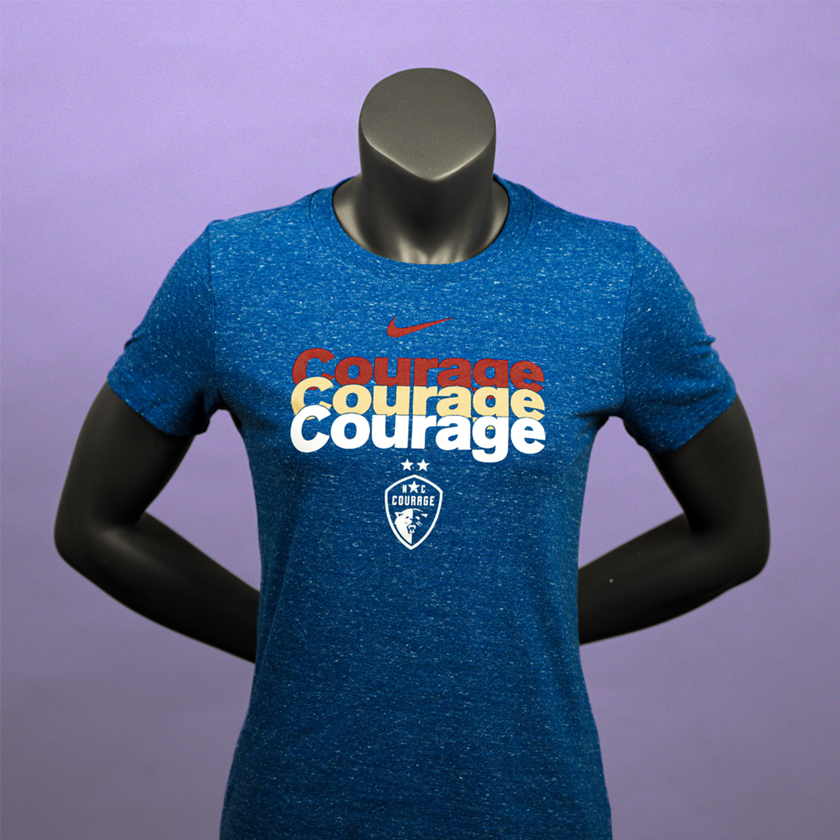 A mannequin wearing a royal blue t-shirt with a repeating pattern of the NC Courage logo in white, yellow, and red text.