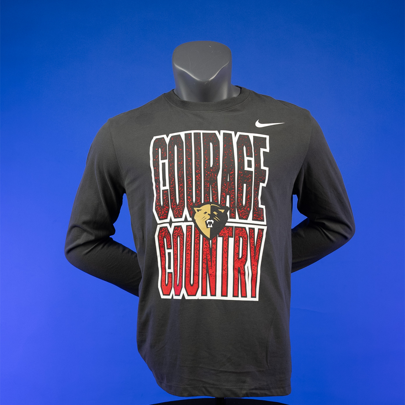 A dark grey long sleeve Nike tee on a mannequin, featuring the text 'COURAGE COUNTRY' and the NC Courage logo.